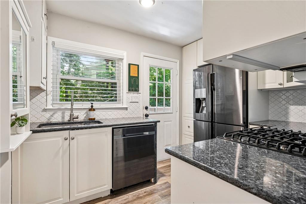 1010 Scott Boulevard, Unit A6 Decatur, GA 30030 - Photo 6 of 26 a kitchen with stainless steel appliances granite countertop a sink stove and refrigerator