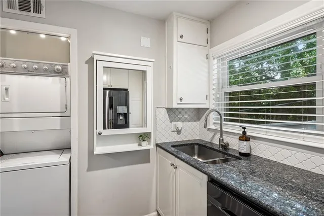 a kitchen with a sink and a refrigerator