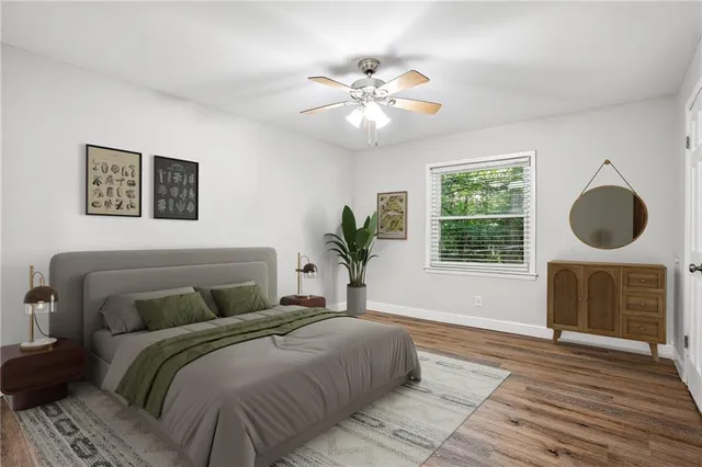 a bedroom with a large bed and a chandelier