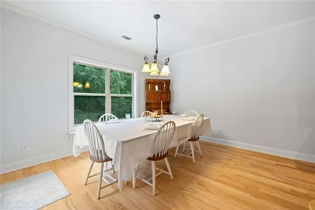 a large kitchen with stainless steel appliances wooden cabinets a stove and a sink