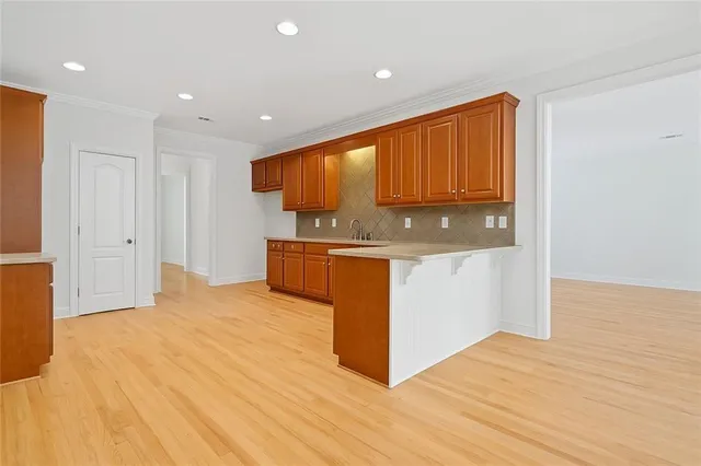 a kitchen with stainless steel appliances granite countertop a stove a sink dishwasher and a microwave oven with cabinets