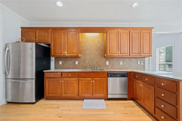 a kitchen with stainless steel appliances granite countertop a refrigerator and cabinets