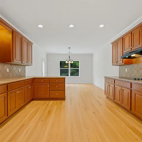 a kitchen with sink window and cabinets