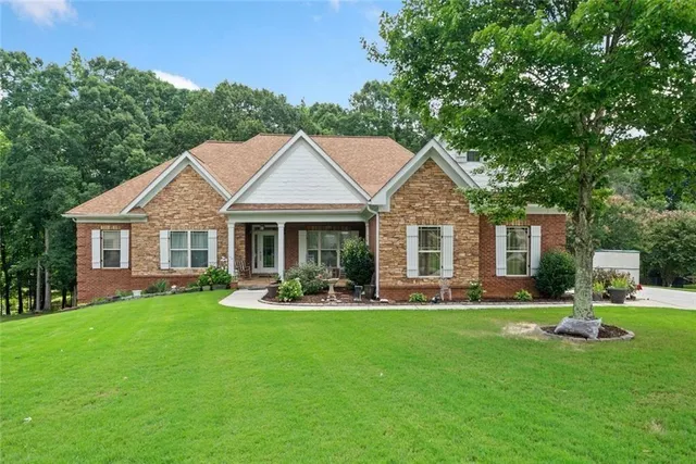 a front view of a house with a yard and porch