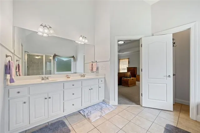 a spacious bathroom with a granite countertop sink shower and a mirror
