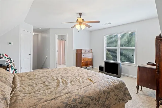 a bedroom with a large bed and a window