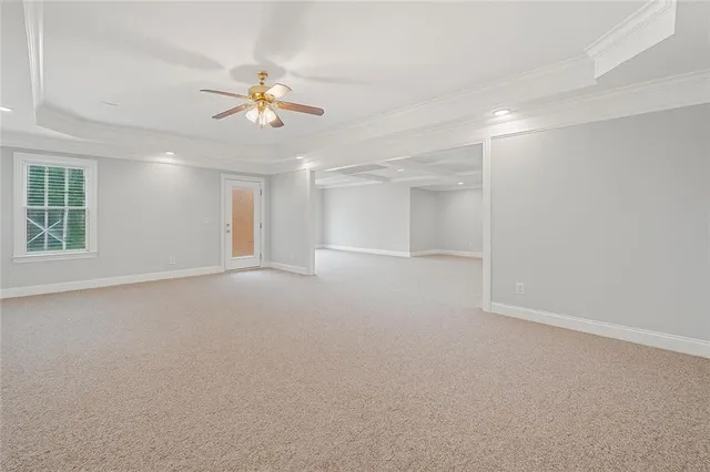 a view of a livingroom with a ceiling fan and window