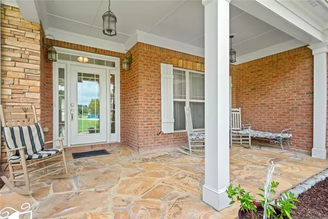 a view of a porch with a table and chairs