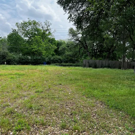 a view of field with trees in the background