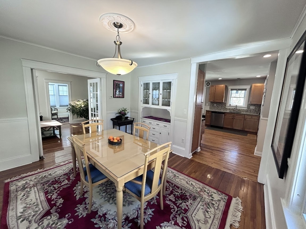 17 Longfellow Road Worcester, MA 01602 - Photo 4 of 19 a dining room with wooden floor a chandelier a wooden table and chairs
