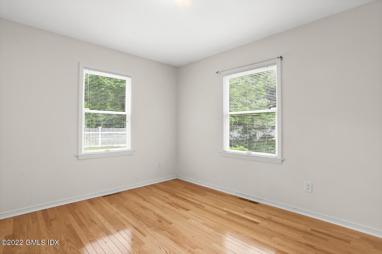 75 Fairfield Road Greenwich, CT 06830 - Photo 11 of 18 a view of an empty room with wooden floor and a window