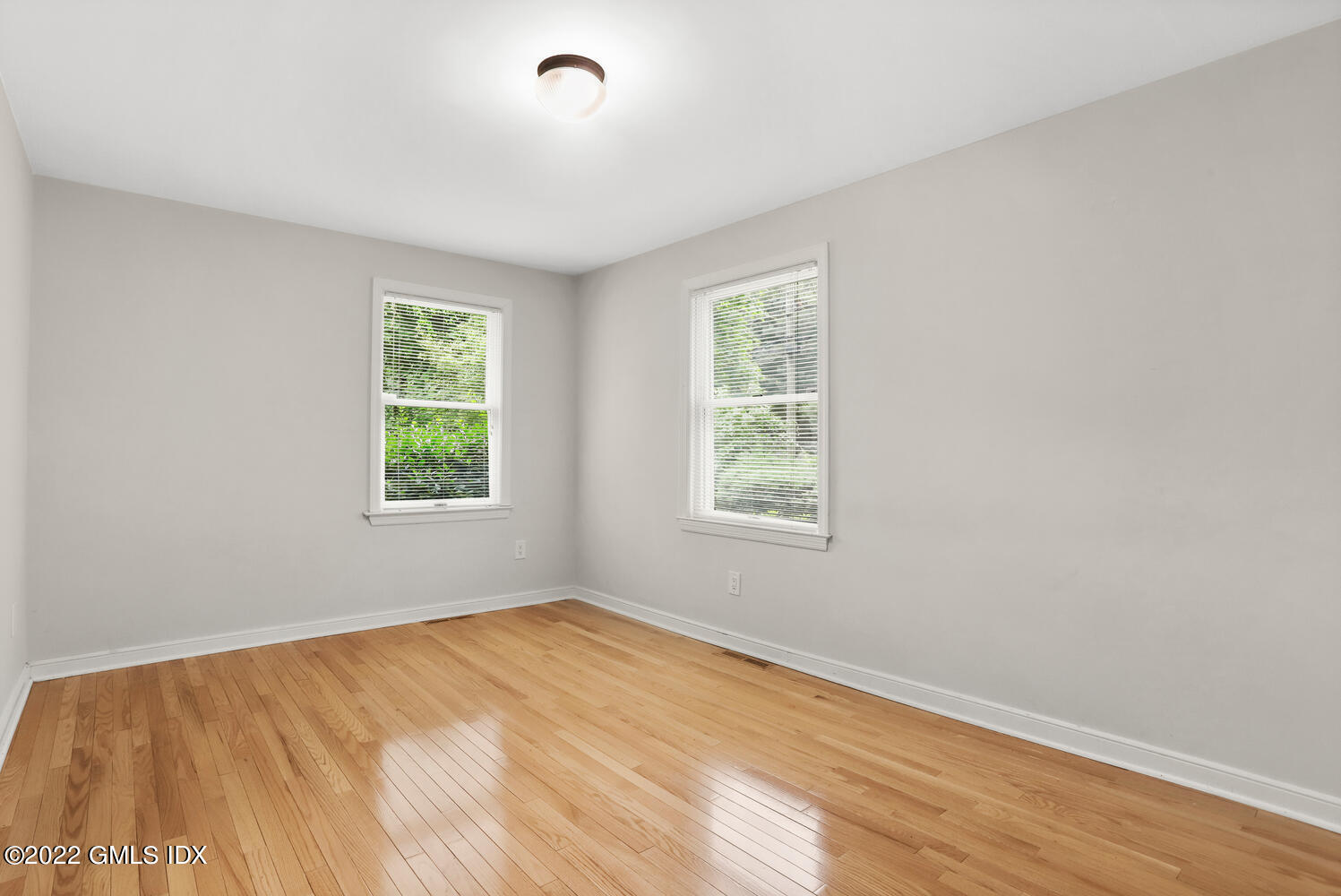 75 Fairfield Road Greenwich, CT 06830 - Photo 12 of 18 an empty room with wooden floor and windows