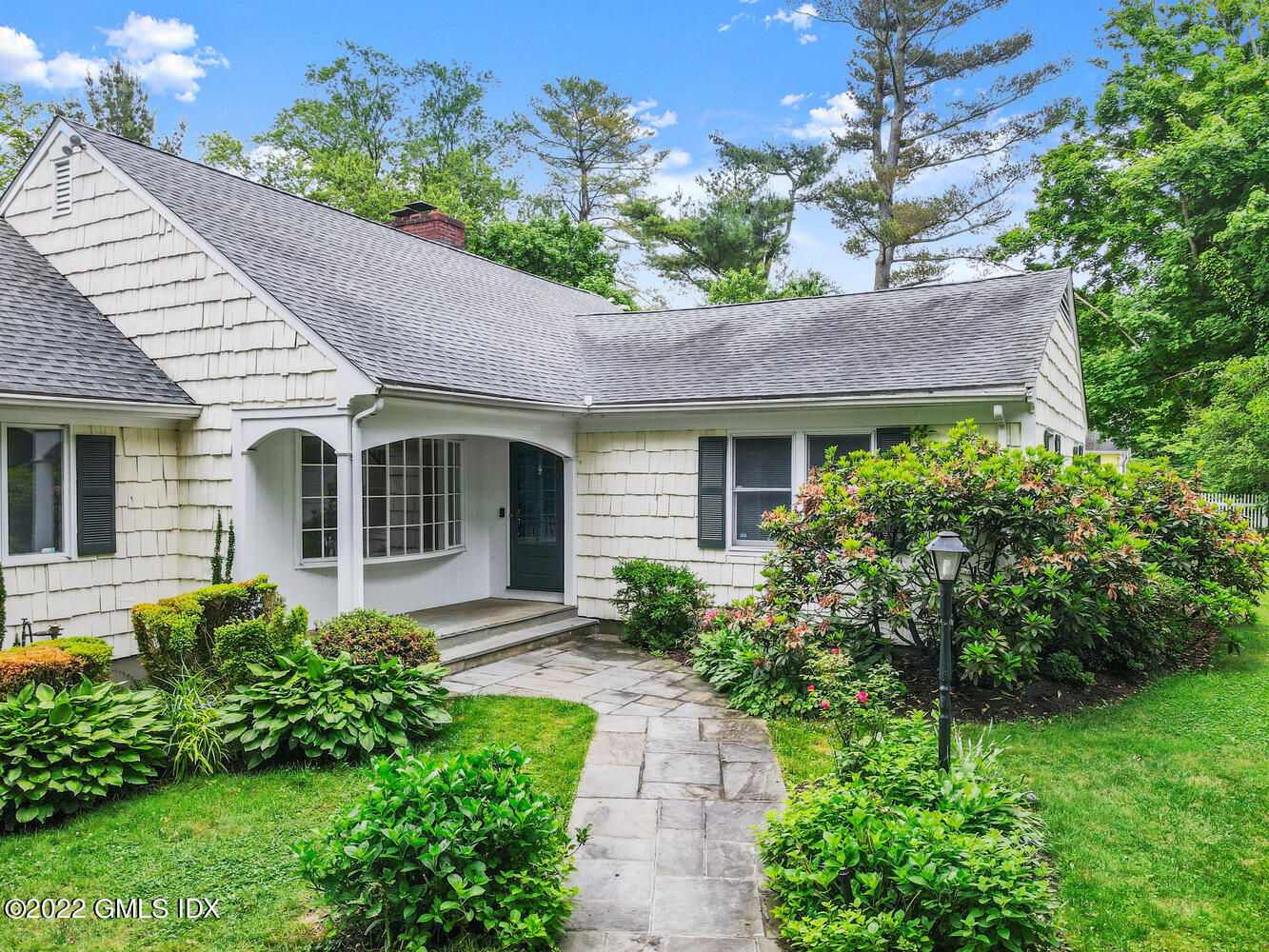 75 Fairfield Road Greenwich, CT 06830 - Photo 13 of 18 a front view of a house with a garden