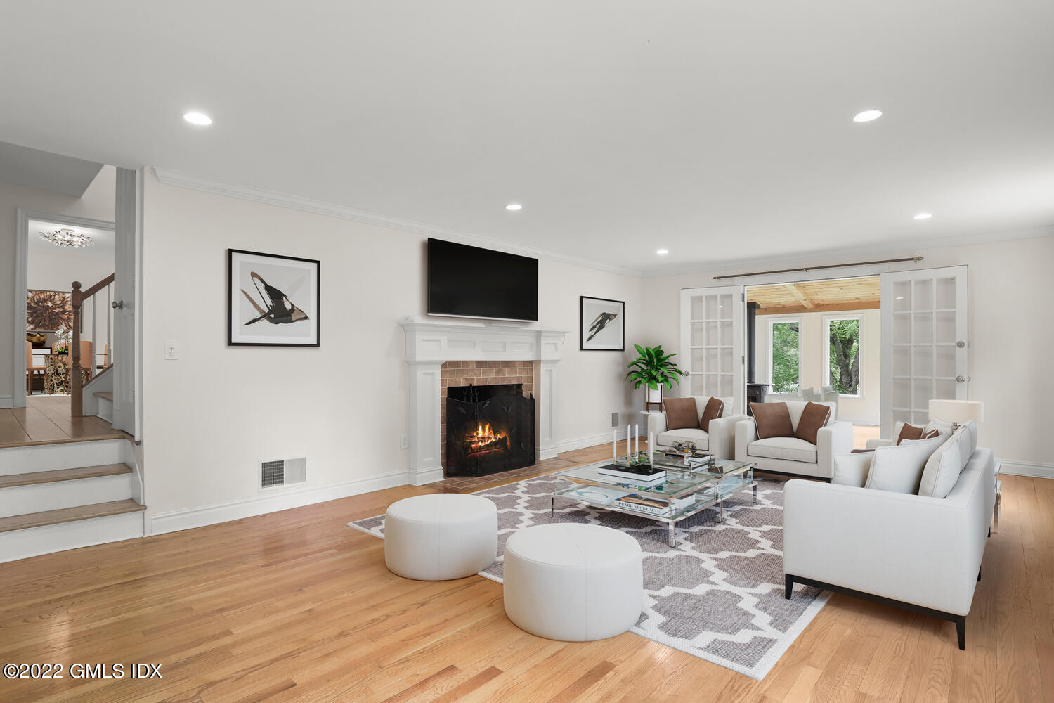75 Fairfield Road Greenwich, CT 06830 - Photo 4 of 18 a living room with furniture a fireplace and a flat screen tv