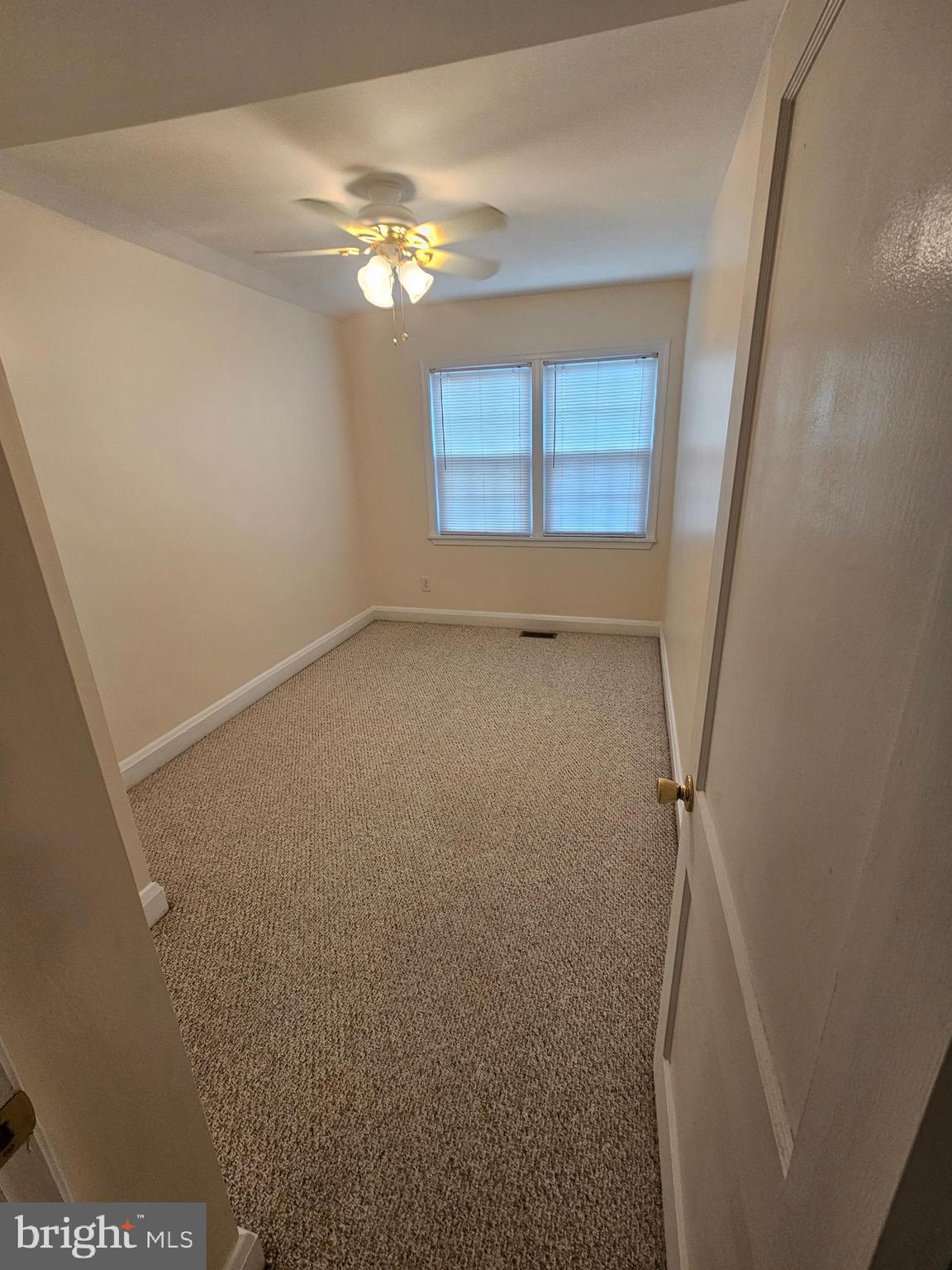 6907 Belclare Road Baltimore, MD 21222 - Photo 12 of 26 a view of an empty room with a window