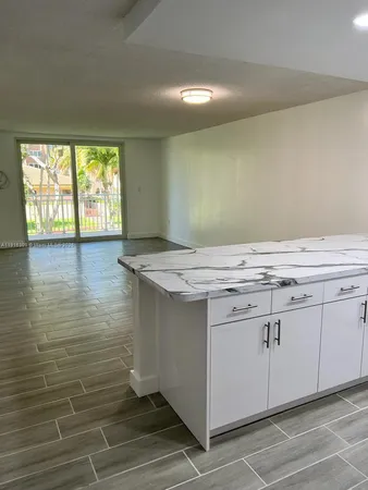 a view of a kitchen with an empty space and window