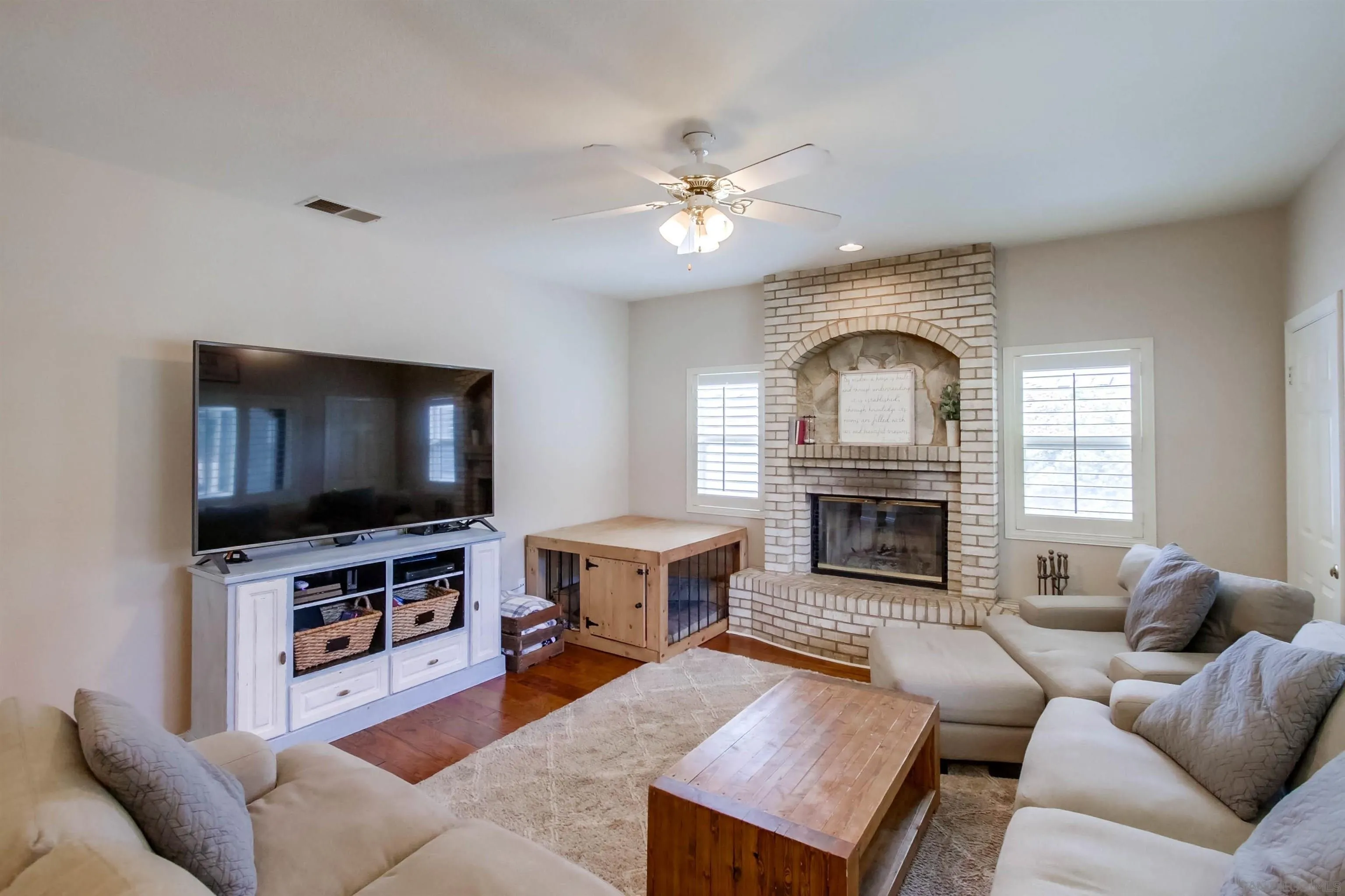 16304 Dartolo Road Ramona, CA 92065 - Photo 14 of 64 a living room with furniture a fireplace and a flat screen tv