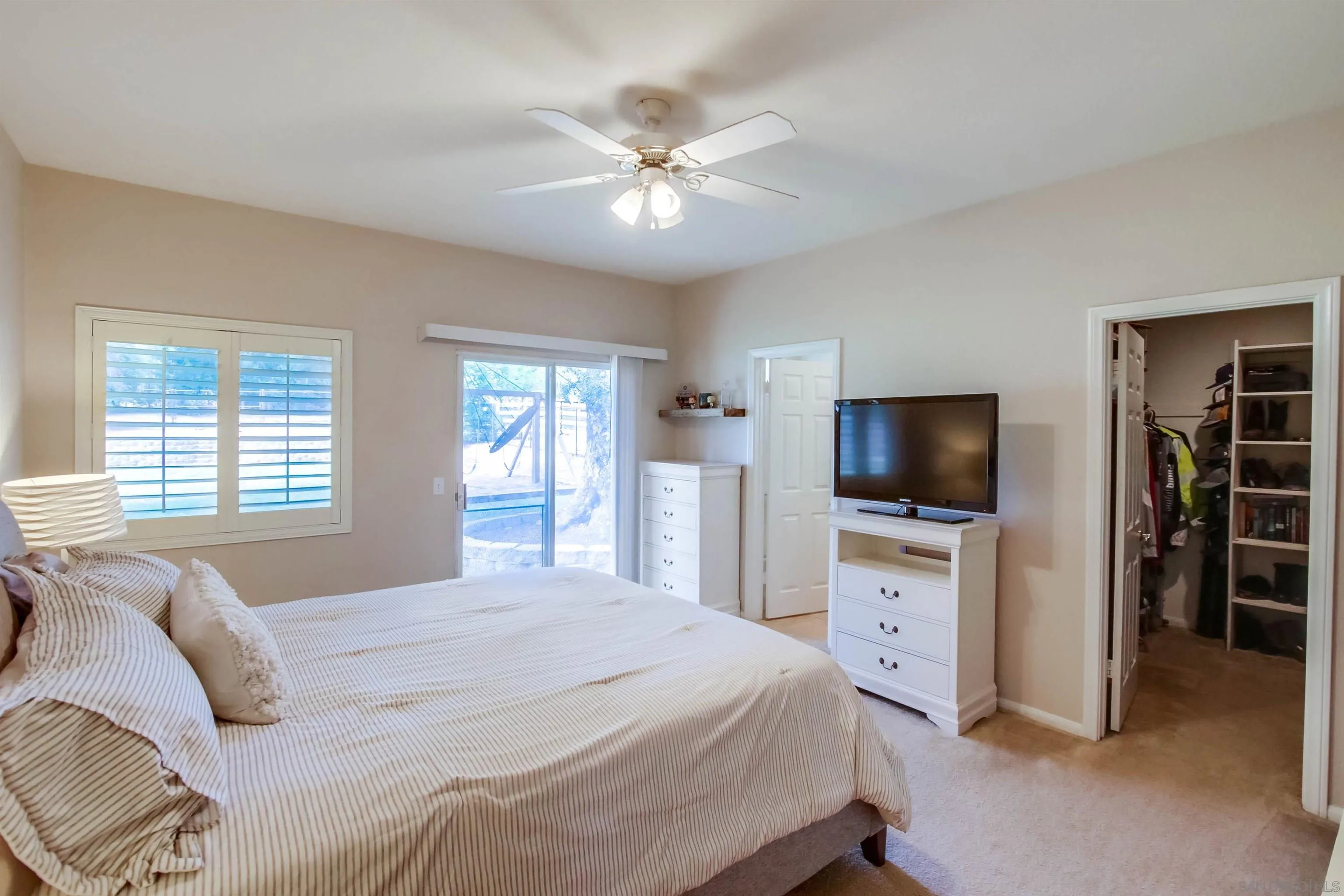 16304 Dartolo Road Ramona, CA 92065 - Photo 29 of 64 a bedroom with a bed a television and a fireplace