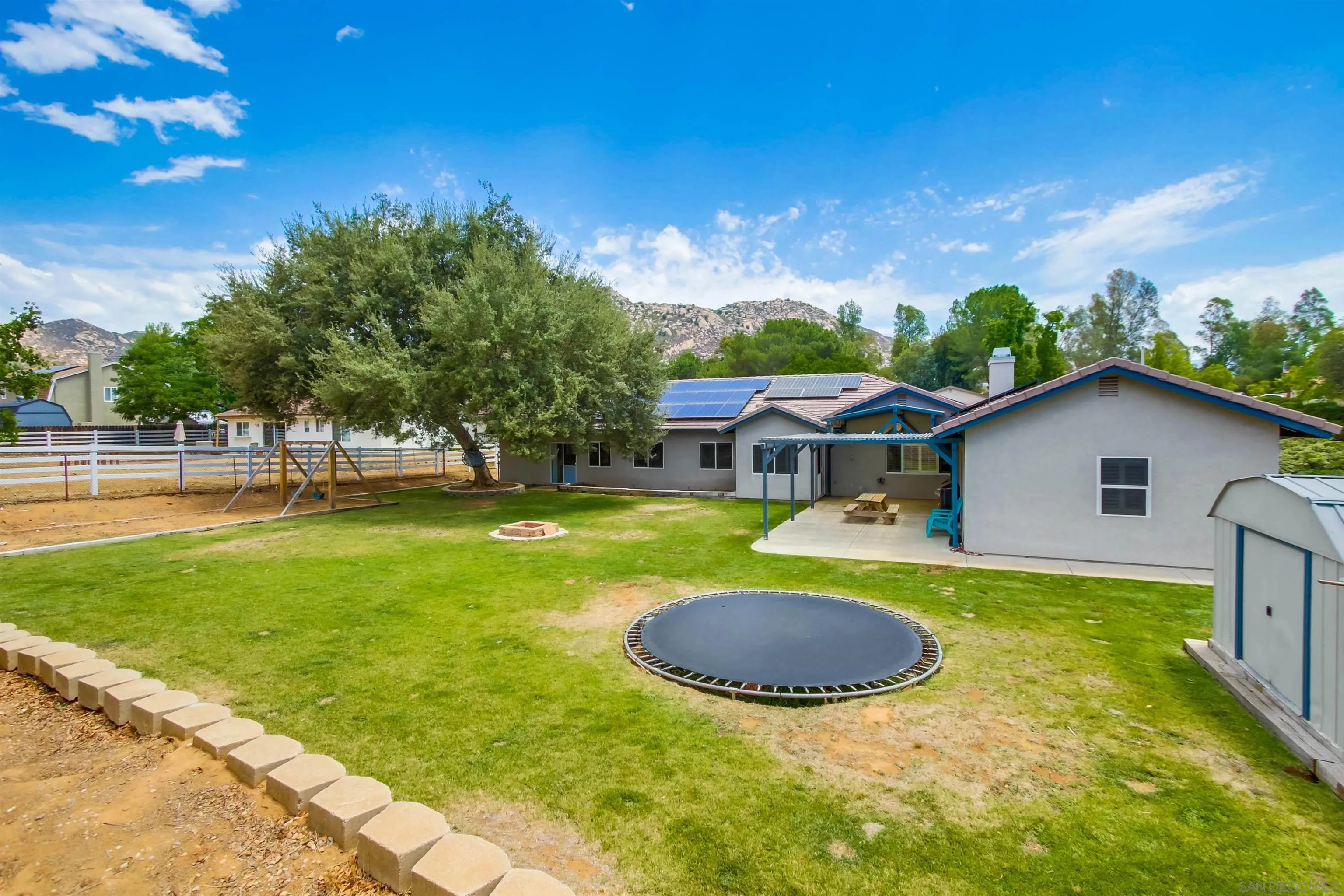 16304 Dartolo Road Ramona, CA 92065 - Photo 47 of 64 a view of a house with swimming pool and a yard