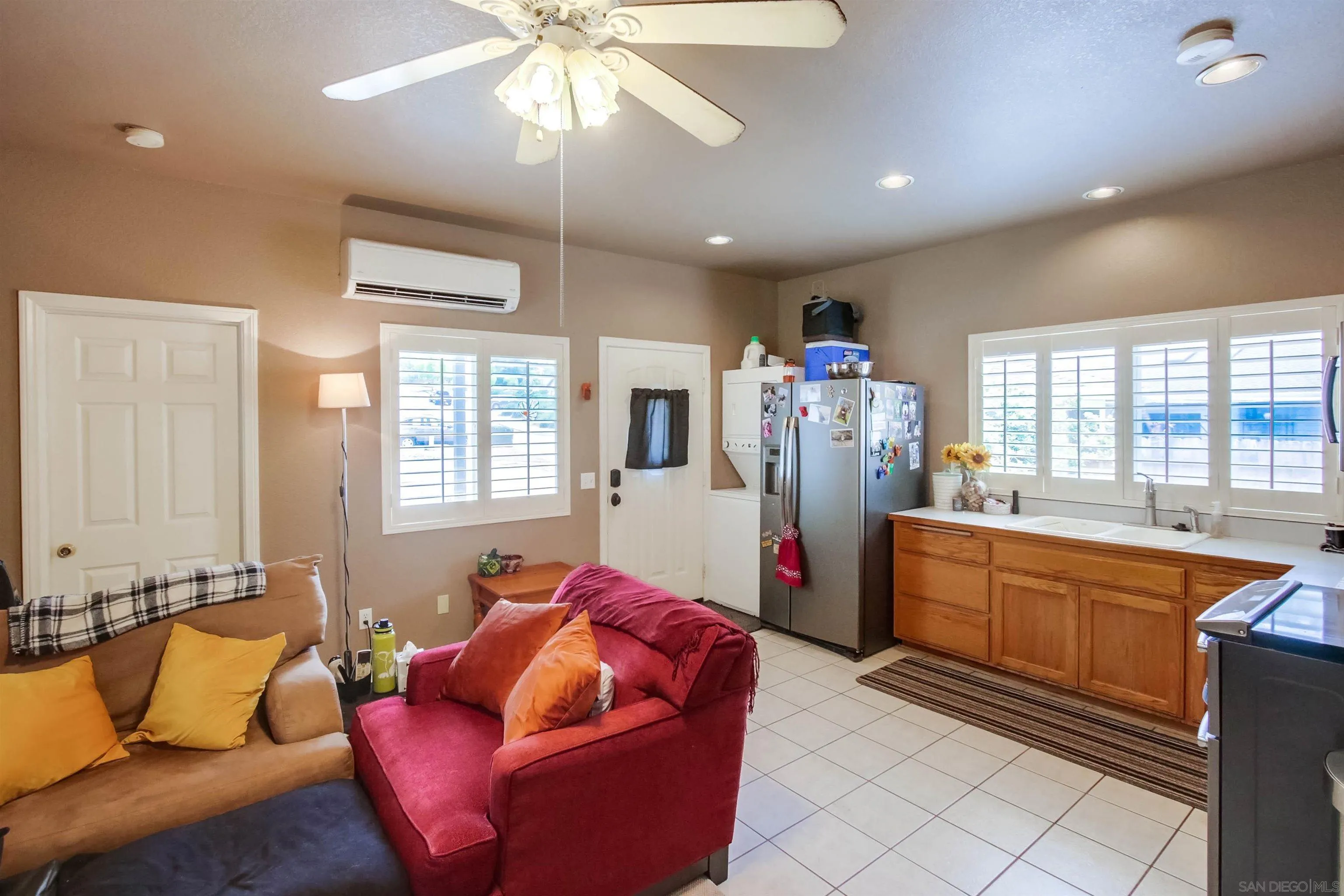 16304 Dartolo Road Ramona, CA 92065 - Photo 54 of 64 a living room with furniture a flat screen tv and a chandelier