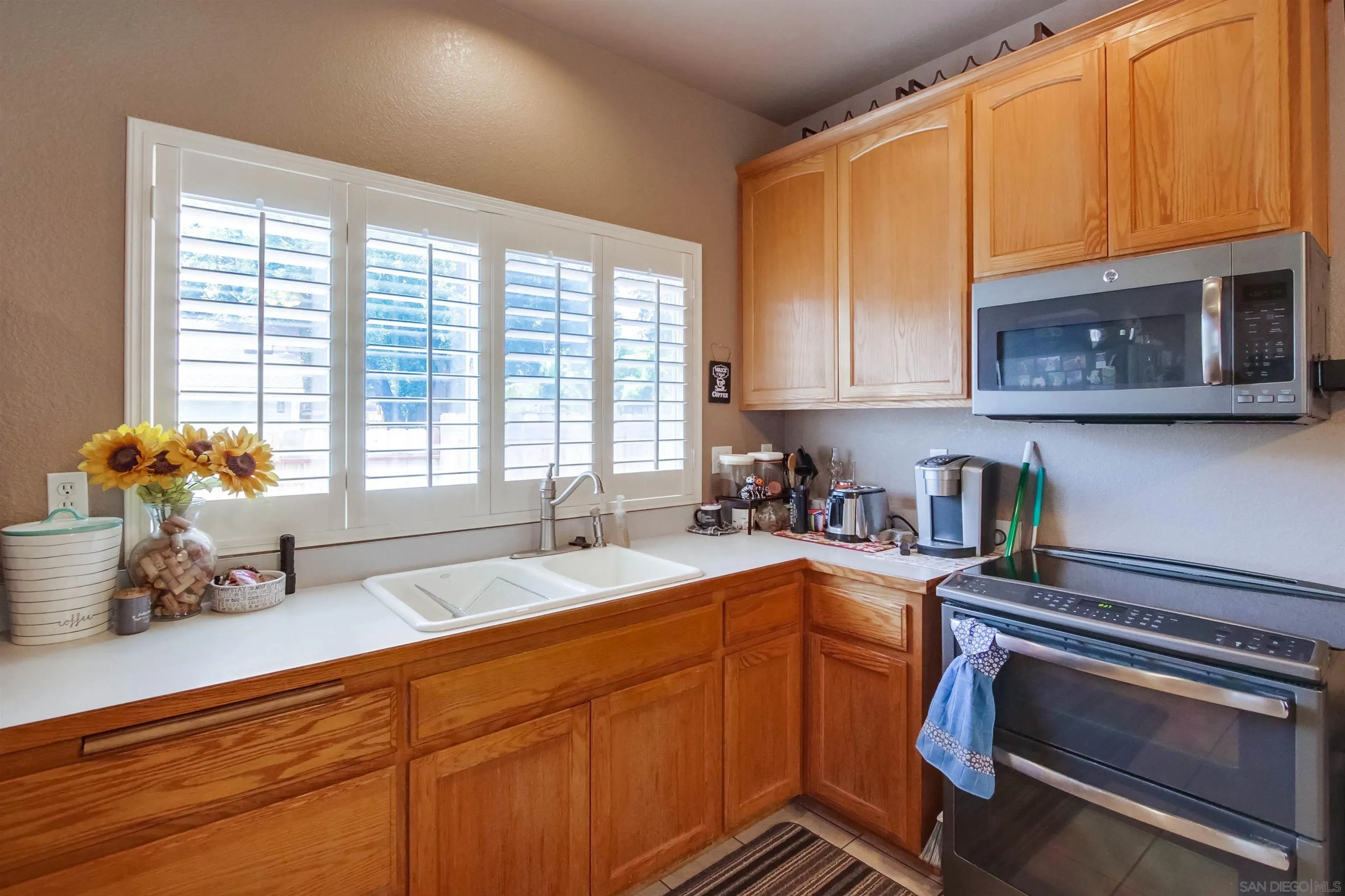 16304 Dartolo Road Ramona, CA 92065 - Photo 55 of 64 a kitchen with a sink cabinets and window