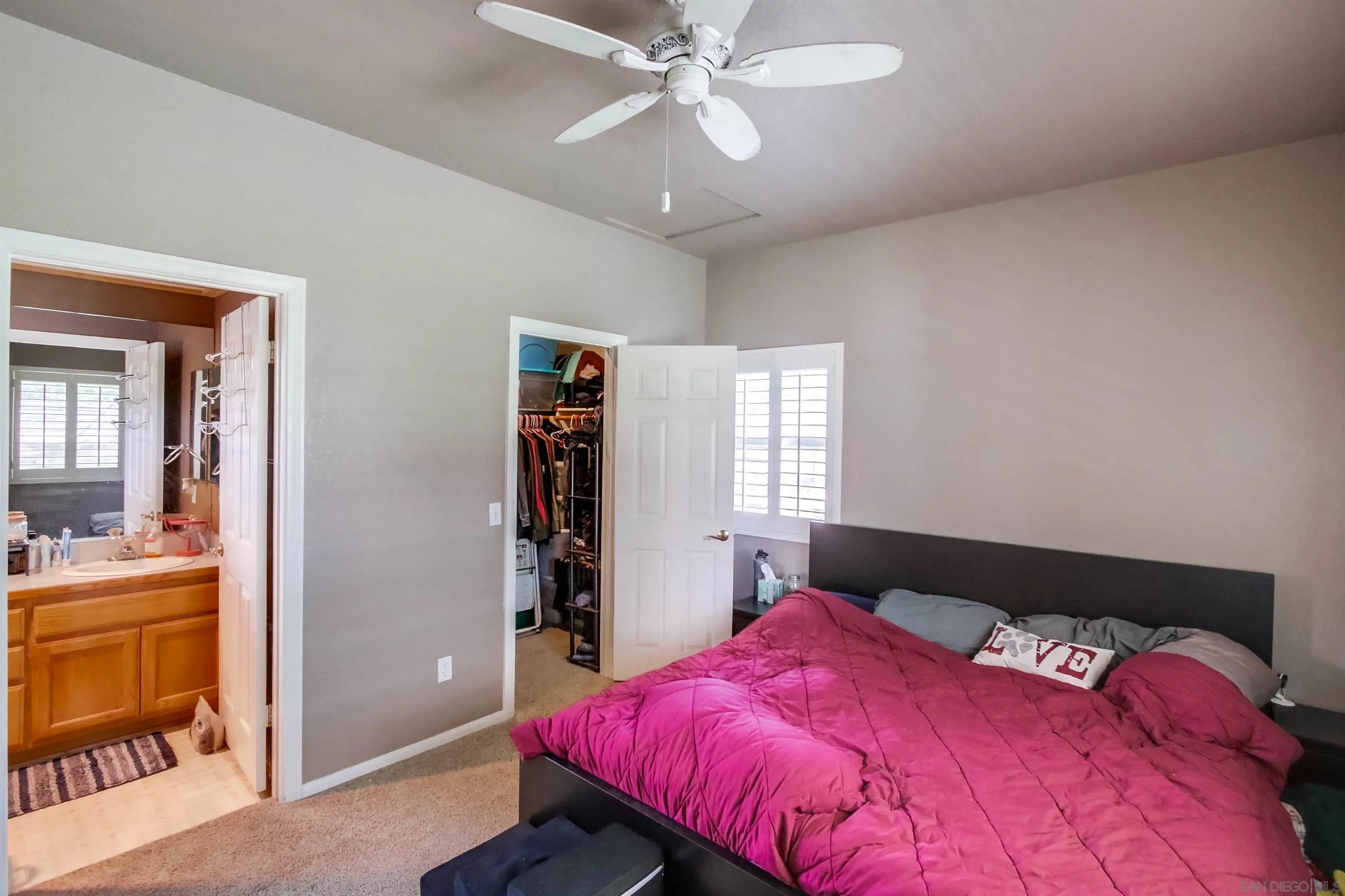 16304 Dartolo Road Ramona, CA 92065 - Photo 57 of 64 a bedroom with a bed and a chandelier