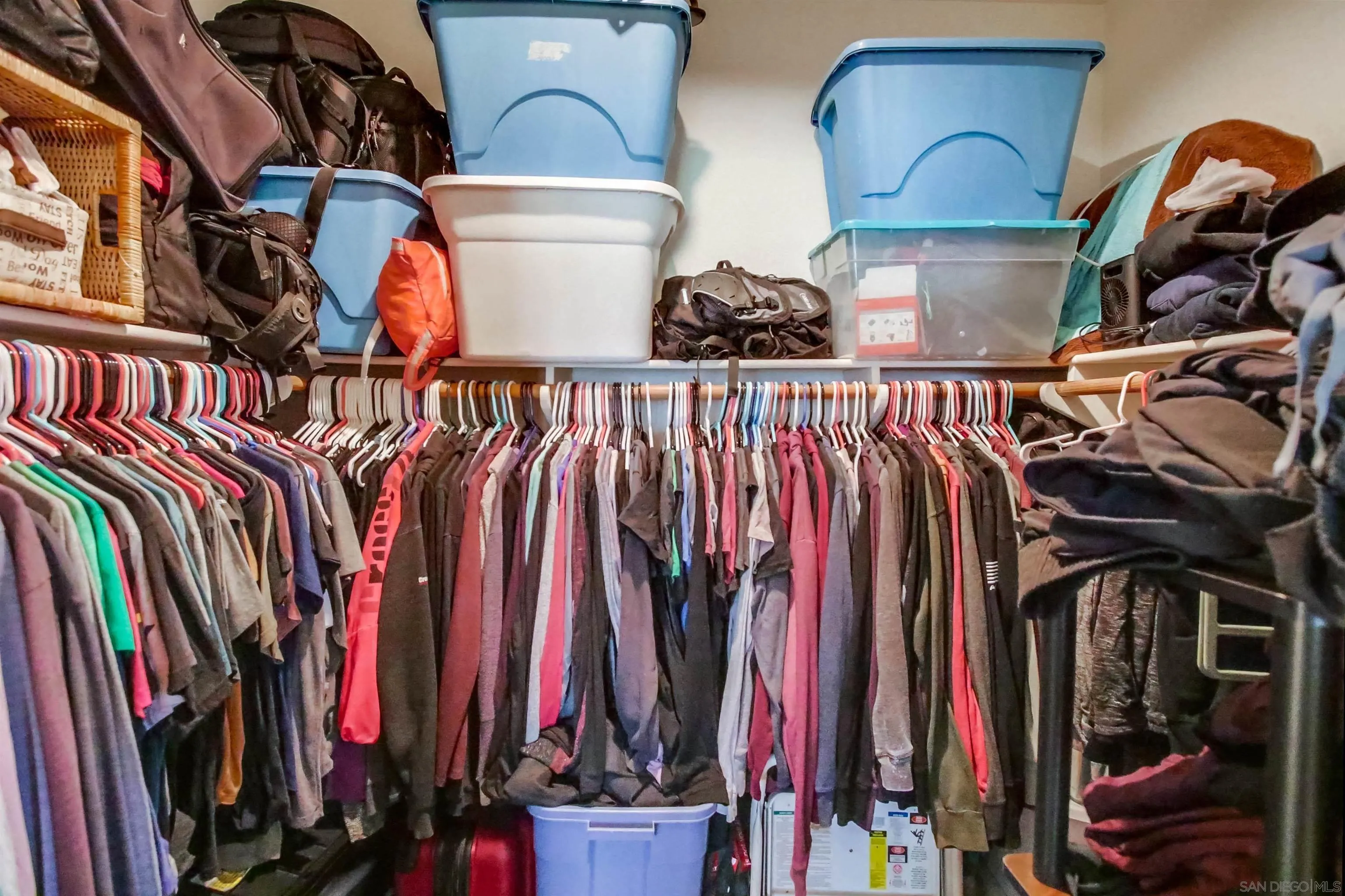 16304 Dartolo Road Ramona, CA 92065 - Photo 59 of 64 a view of walk in closet with clothes and shoes