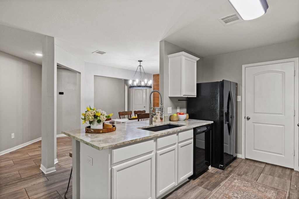 217 Farmer Lane Jarrell, TX 76537 - Photo 5 of 29 An inviting open-concept kitchen features ample counter space, perfect for entertaining.