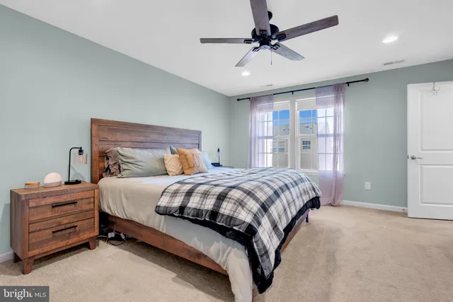 a bedroom with a bed dresser and a window