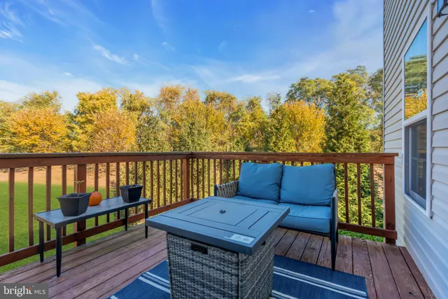a view of roof deck with two chairs and wooden floor