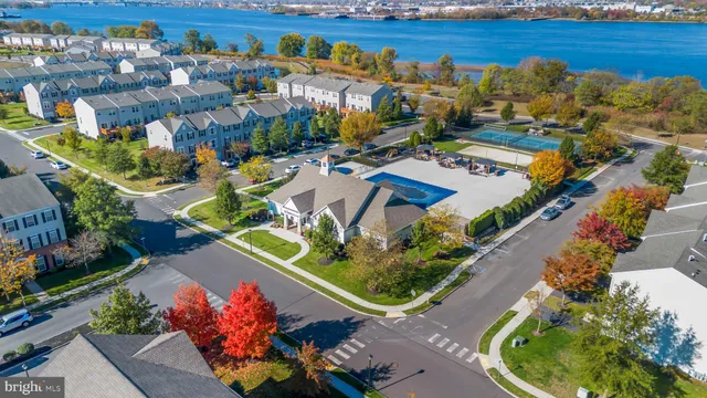 an aerial view of a house with a garden and lake view