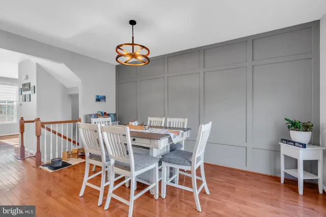 a view of a dining room with furniture wooden floor and chandelier