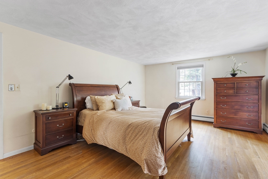 7 Countryside Road Natick, MA 01760 - Photo 19 of 37 a bedroom with a bed and wooden floor