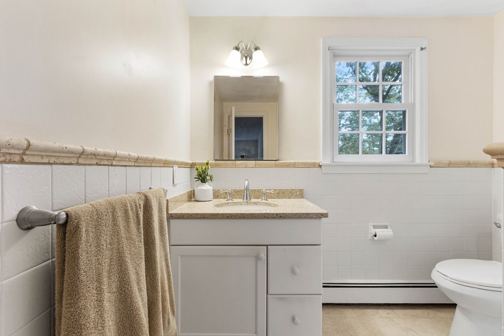 7 Countryside Road Natick, MA 01760 - Photo 21 of 37 a bathroom with a sink a toilet and mirror