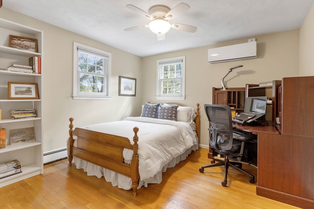 7 Countryside Road Natick, MA 01760 - Photo 24 of 37 a bedroom with a bed and a chandelier
