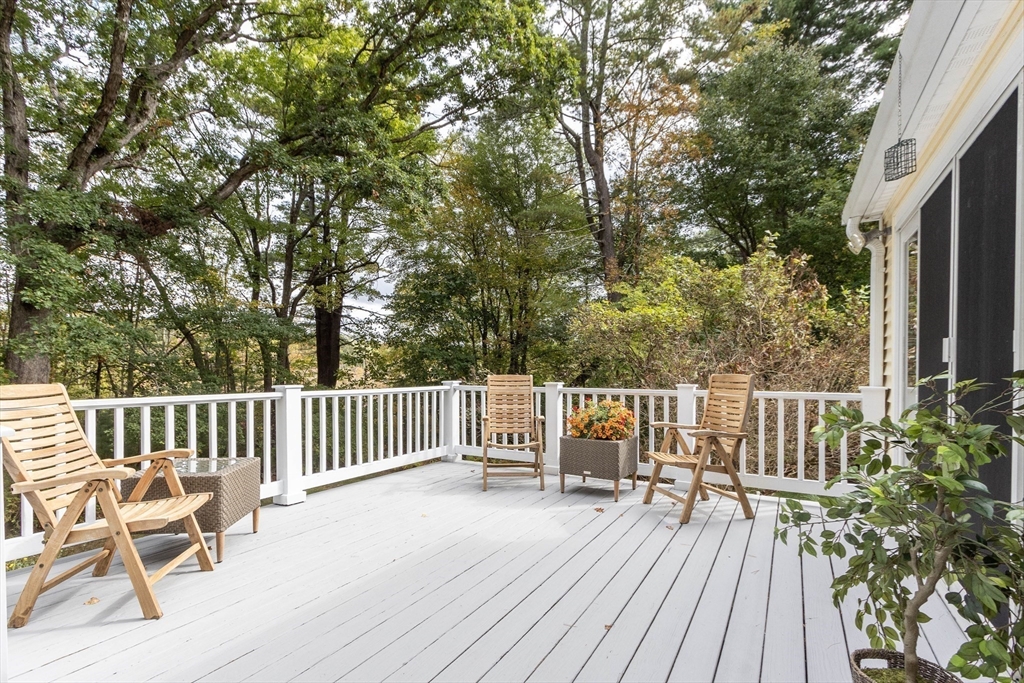 7 Countryside Road Natick, MA 01760 - Photo 26 of 37 a view of a deck with two chairs and wooden floor