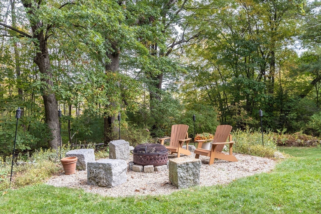 7 Countryside Road Natick, MA 01760 - Photo 29 of 37 a view of a patio with table and chairs potted plants with large tree
