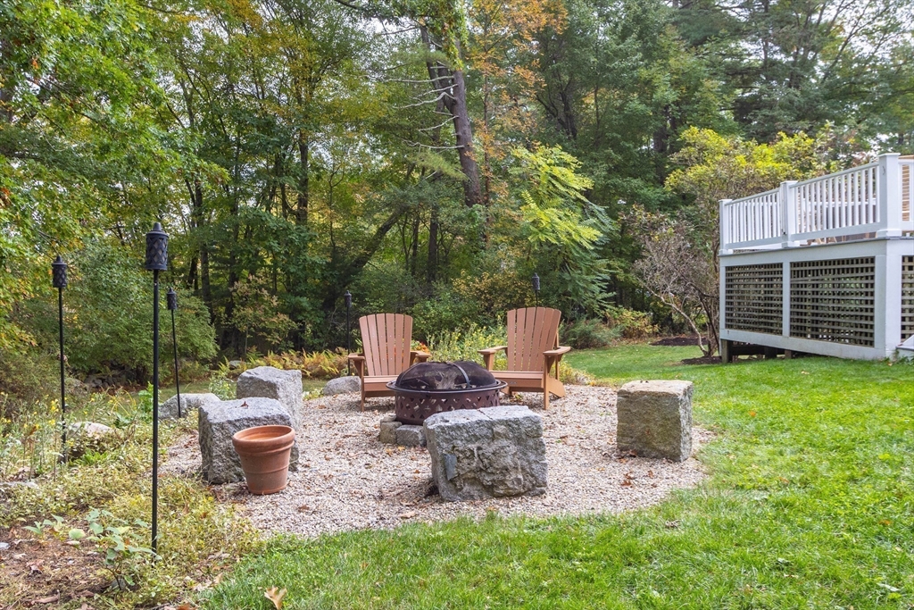 7 Countryside Road Natick, MA 01760 - Photo 30 of 37 a view of a chair and tables under an umbrella