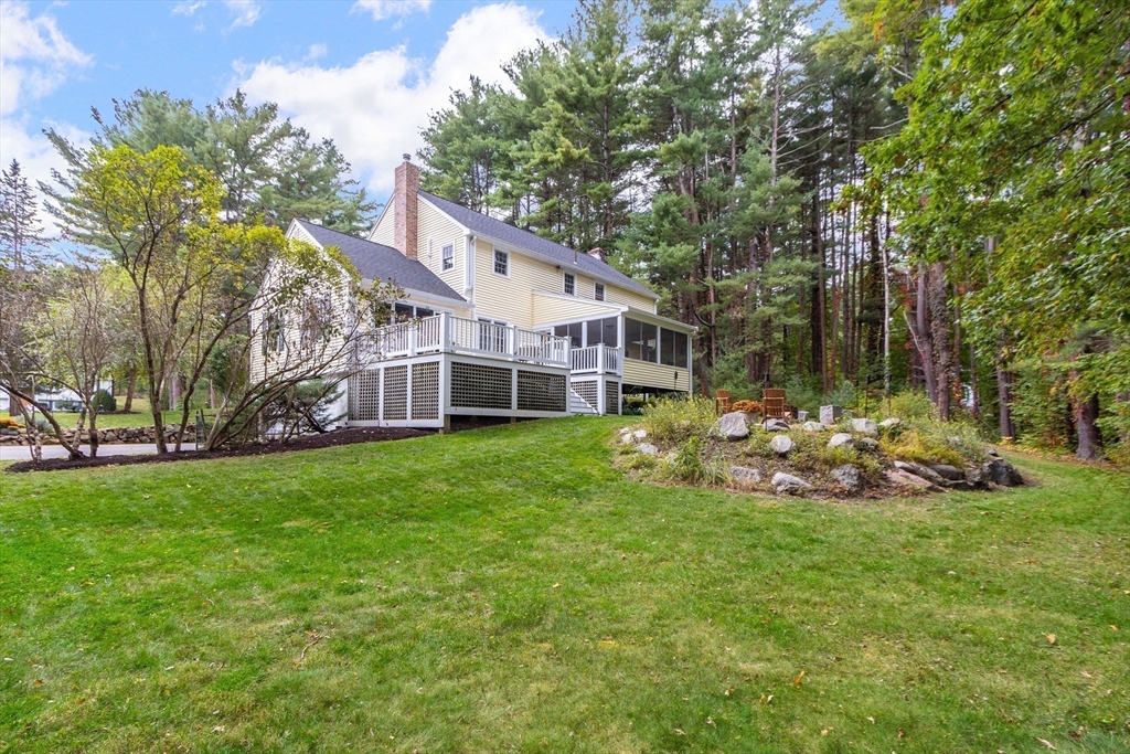 7 Countryside Road Natick, MA 01760 - Photo 32 of 37 a view of a house with a big yard and sitting area