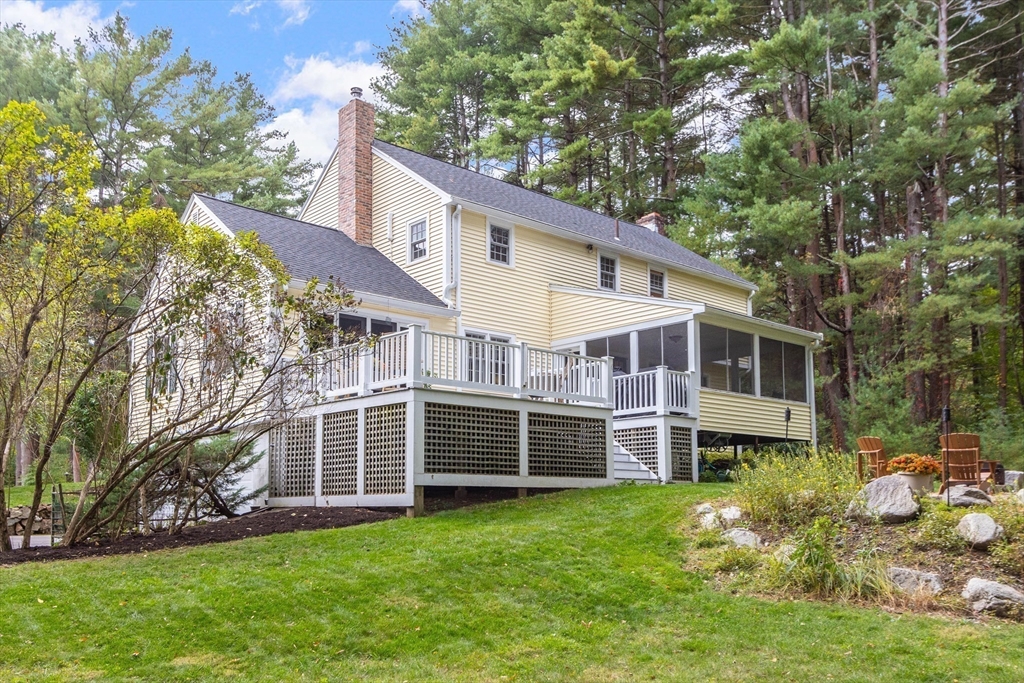 7 Countryside Road Natick, MA 01760 - Photo 33 of 37 a view of a house with a yard and sitting area
