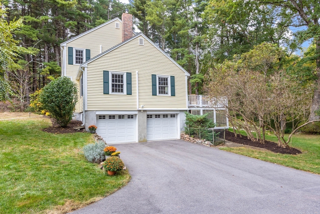 7 Countryside Road Natick, MA 01760 - Photo 36 of 37 a front view of a house with a yard and garage