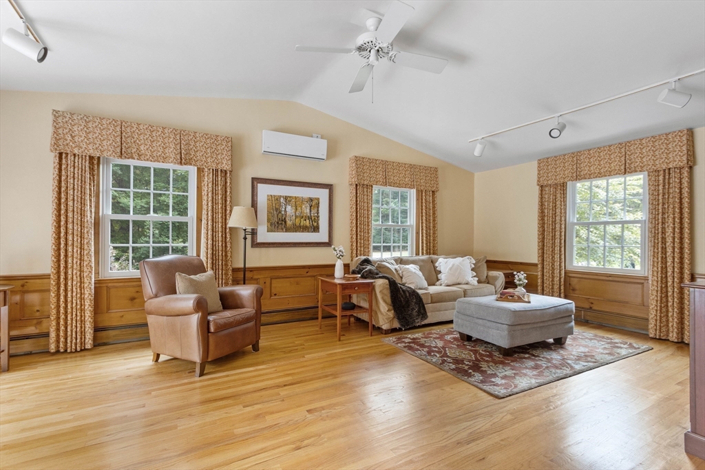 7 Countryside Road Natick, MA 01760 - Photo 4 of 37 a living room with furniture and floor to ceiling windows