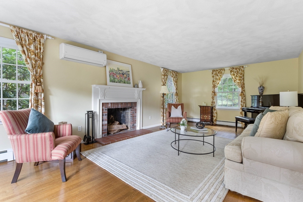 7 Countryside Road Natick, MA 01760 - Photo 7 of 37 a living room with furniture and a fireplace