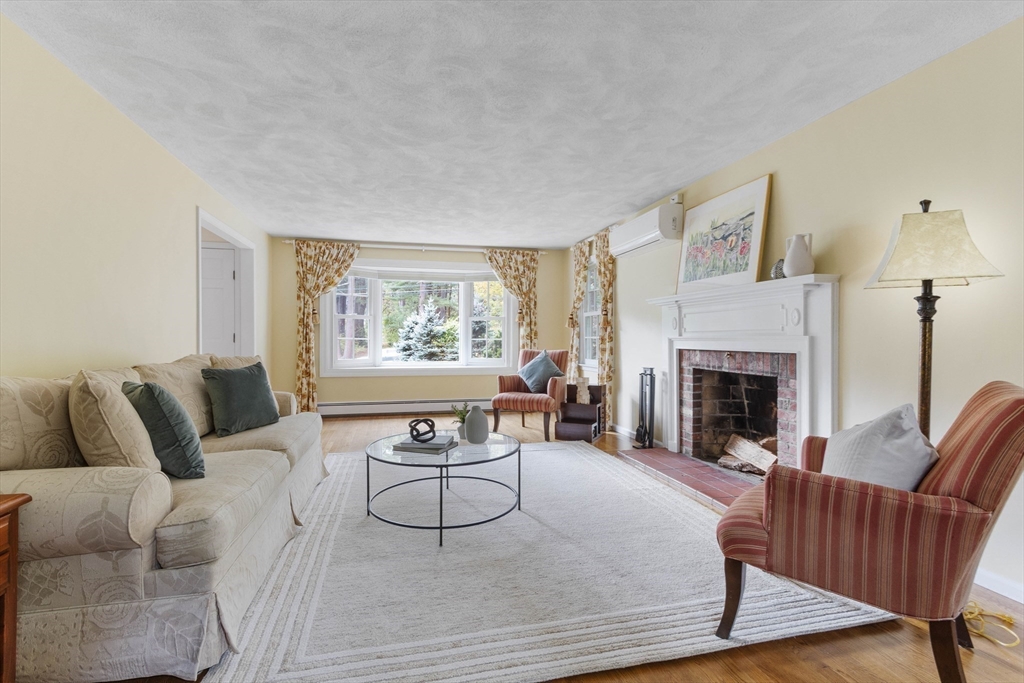 7 Countryside Road Natick, MA 01760 - Photo 8 of 37 a living room with furniture and a fireplace