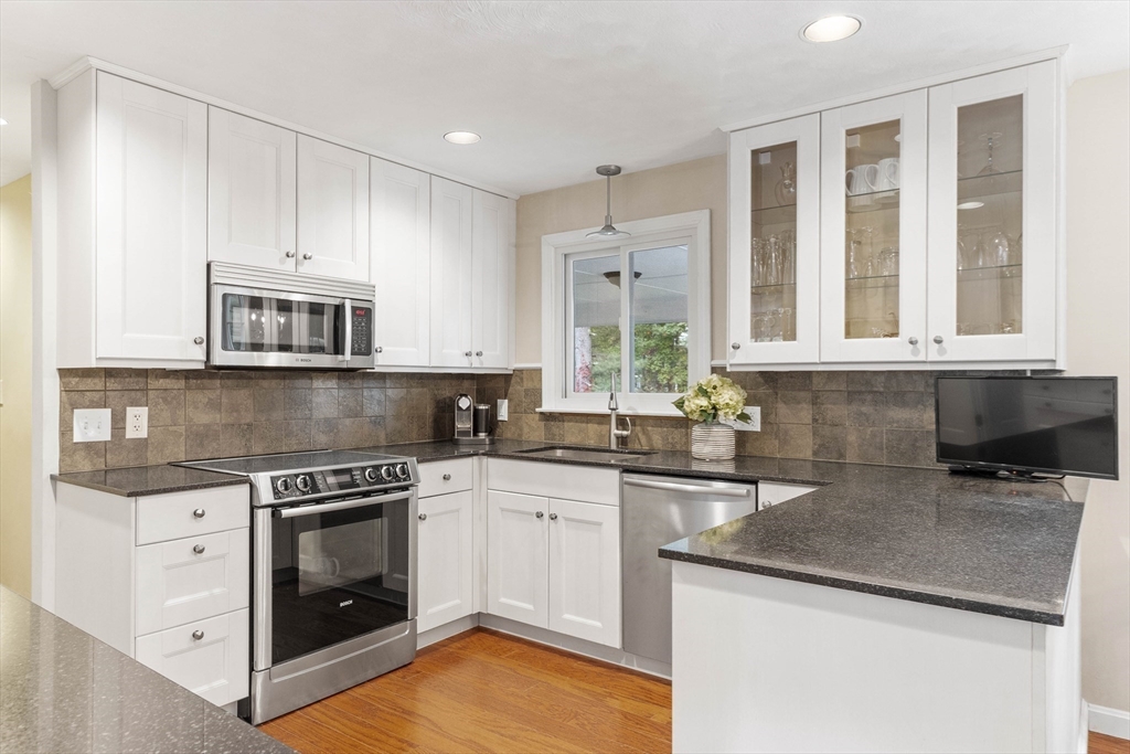 7 Countryside Road Natick, MA 01760 - Photo 10 of 37 a kitchen with stainless steel appliances granite countertop a stove sink and cabinets