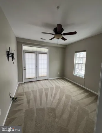 a view of an empty room and a window