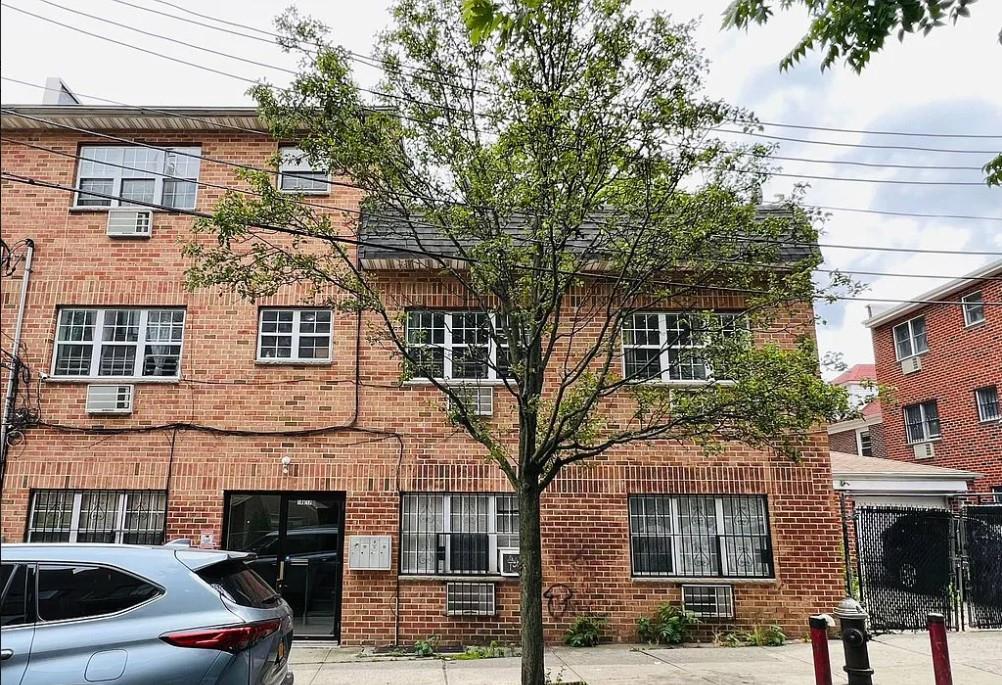 109-12 Westside Avenue Queens, NY 11368 - Photo 1 of 5 a front view of a building with parking space