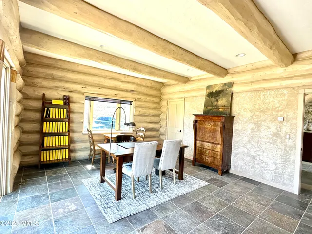 a dining room with furniture and window