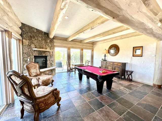 a living room with furniture a rug and a clock