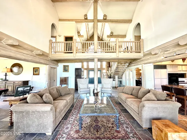 a living room with furniture a fireplace and a large window